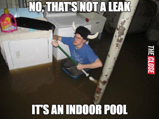 Man clearing flooding in the storage space of his house